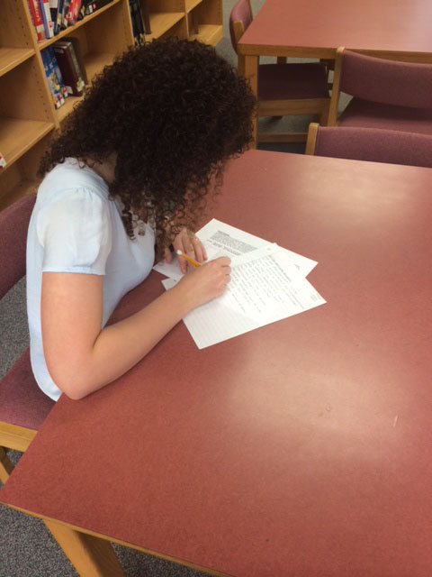 Dana Shefet, sophomore, takes an English test in the Library at Athens Drive. 