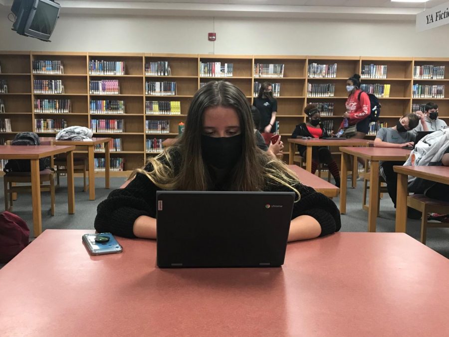 In-person students like Carolina Beacham (pictured) take class virtually from the library if their teacher is not on campus.