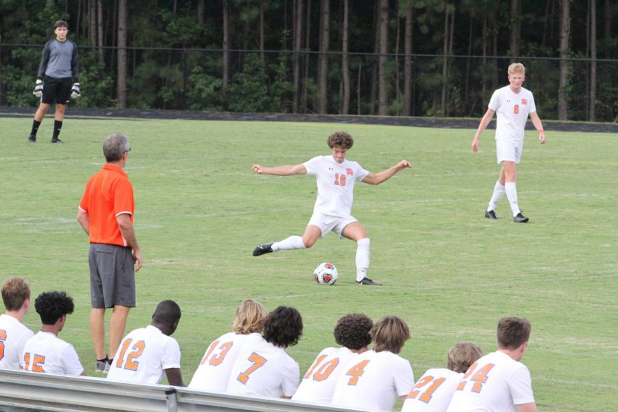 William Angell, senior midfielder, kicks the ball down the field to give the team a chance to score against Apex. Final score 3-0 Apex. Photo contributed by Caiden Orders.