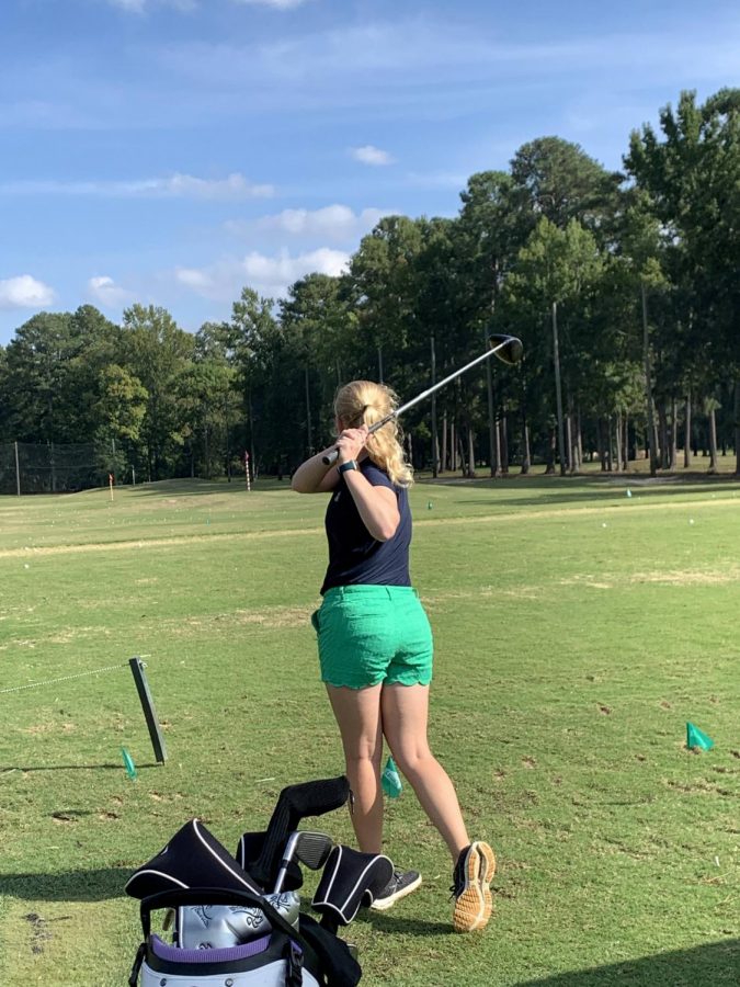Freshman, Susan Mcgraw swinging at golf practice on thursday at Lochmere golf course