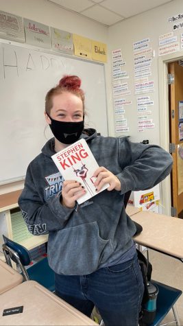 Abagail Bissett proudly holding up the book that took her a month to finish; IT by Stephen King
