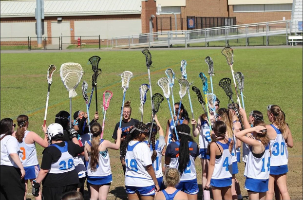 Womens Lacrosse team pumps each other up before they face their opponent on the field.