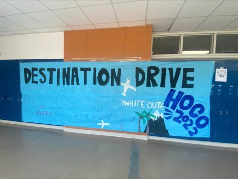 Athens drive spirit week banner posted in a hallway. Listed on the banner is the theme destination, reminding and encouraging students to participate in the event.