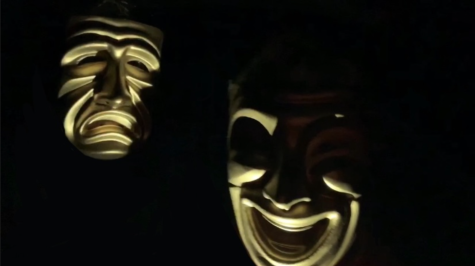 Creepy picture of two people with golden masks in the dark. How much longer will they live?