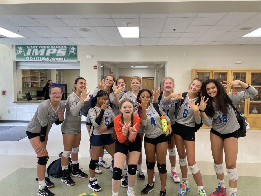 Athens Drive junior varsity volleyball team strikes a pose together for a victory picture after putting in the work to win their game. 