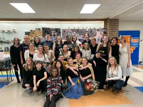 A photo that captured performers and some of the backstage crew after they had finished performing in a previous performance.