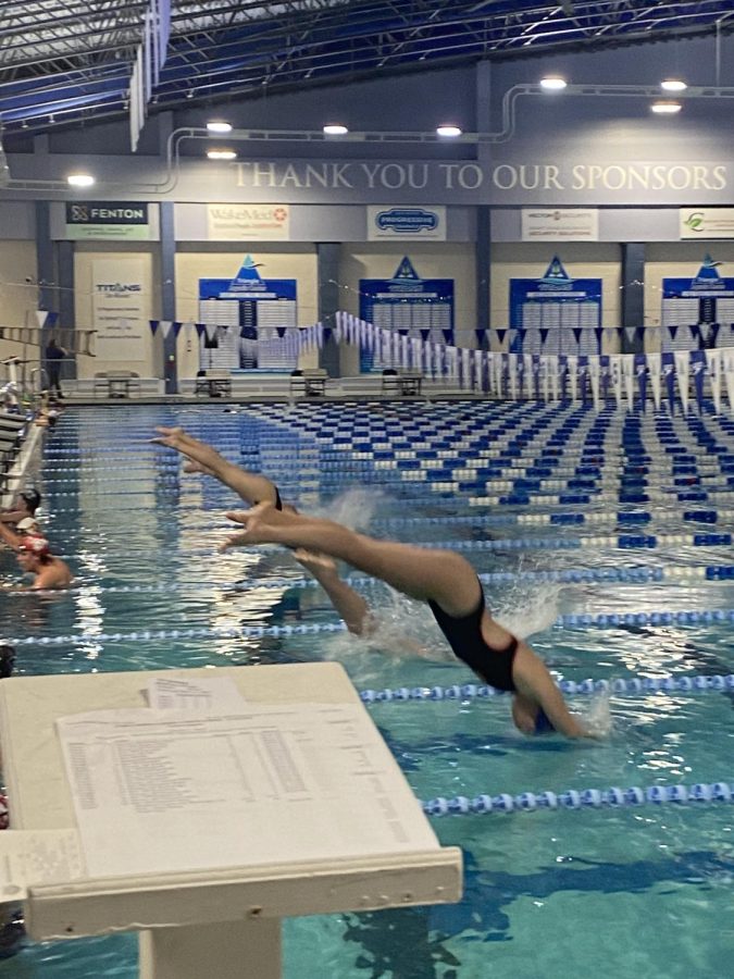Stella Andrews diving into the pool during a big meet. The women’s and men’s swim teams dominated the meet.