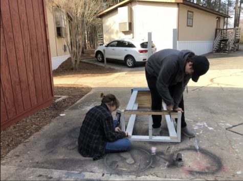 Seussical crew members JD DeLeo and Anya Tikhtman work to build set for performance.