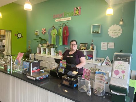 Miranda Schanner manager of sweetFrog preparing to serve her customers some frozen yogurt. She is also having to figure out the amount of proceeds that go to Athens Drive High School.