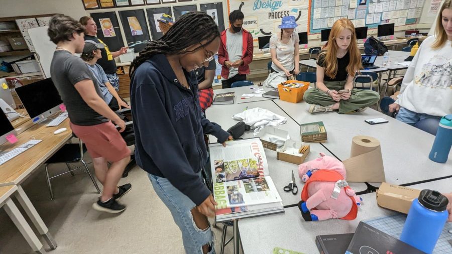 Neveah Brooks in the Yearbook room admiring this year’s yearbook. Brooks was on the yearbook team, as a senior leading the yearbook staff.