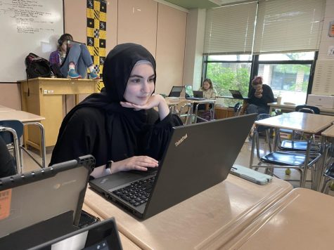 Nassibah Bedreddine focuses on completing an article during her newspaper class. 