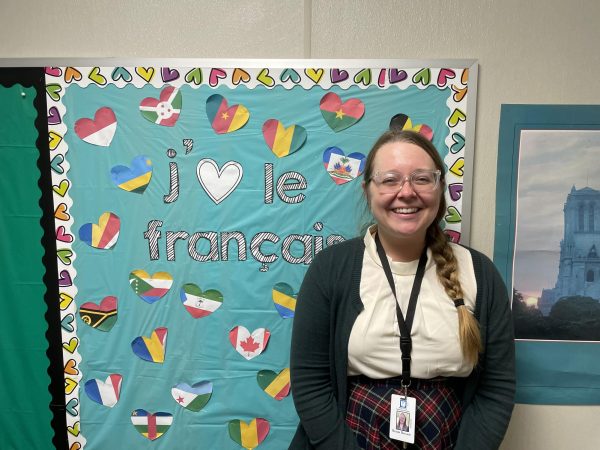 New French teacher, Renata Barsanti, proudly poses outside of her classroom. Barsanti arrived at Athens Drive at the beginning of the 2023-2024 school year, after a variety of teaching experiences. 