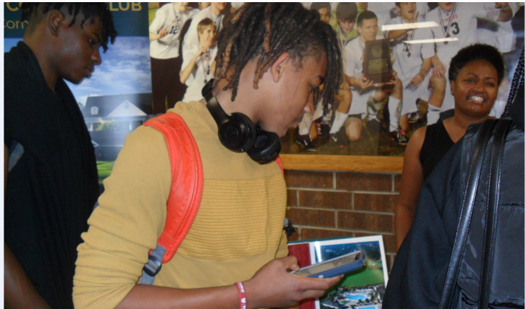 In this picture you have students Tyrre Hester a sophomore and Caleb Jones junior checking out one of the many career fair booths at the Athens Drive career fair.
