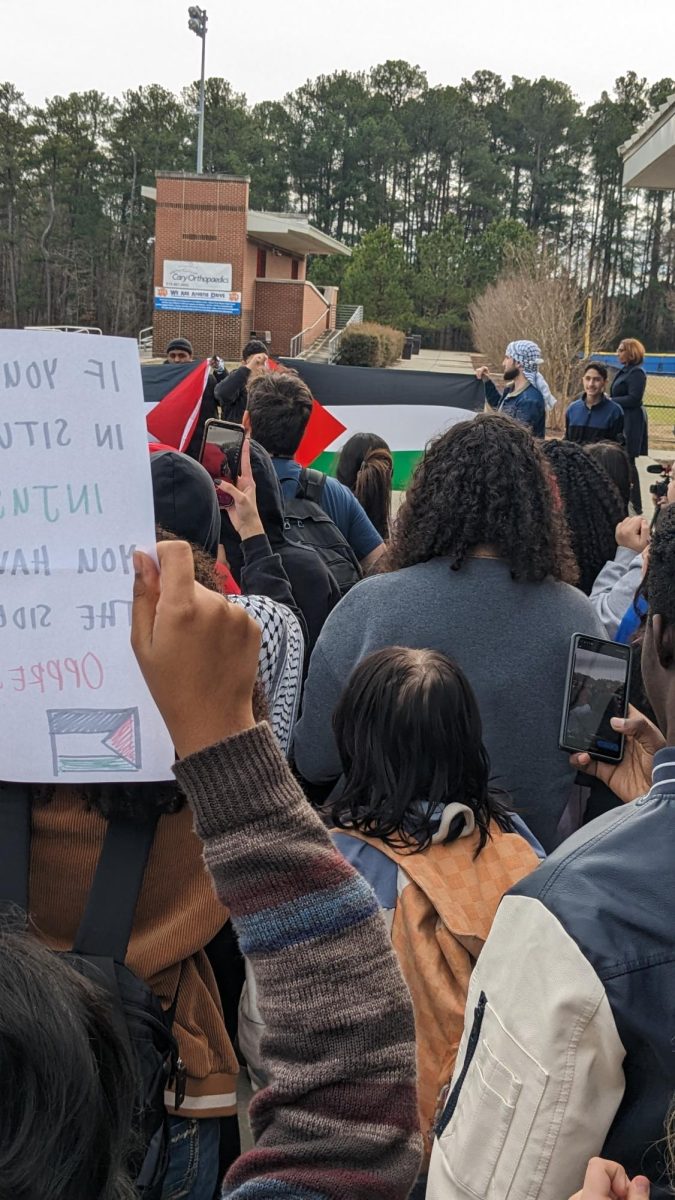 A picture of the protest. Students brought signs, flags, and wore keffiyehs in support. 