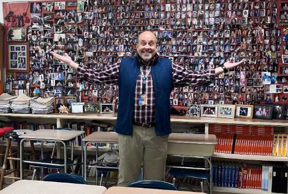 Senior Advisor Christopher Remaley in front of his “wall of seniors”’. Remaley has created this wall over the years he has been at Athens, on this wall are pictures of his favorite seniors.