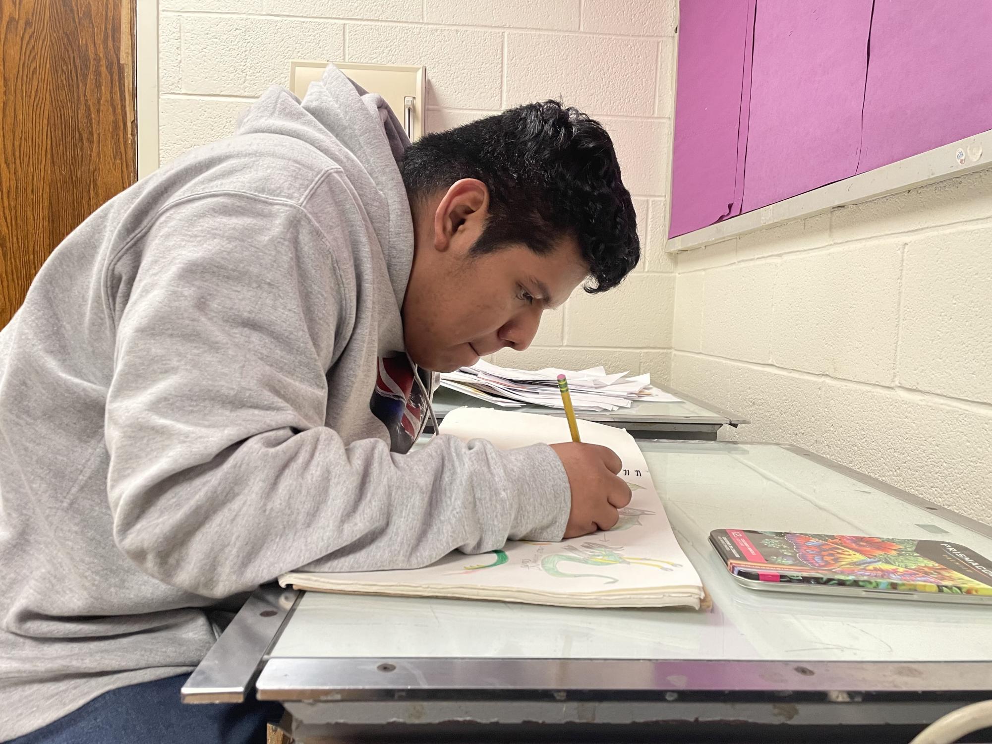 Jason Roblero Perez diligently works on his sketches. Roblero Perez has been committed to comic book creation since he first started drawing in sixth grade. 