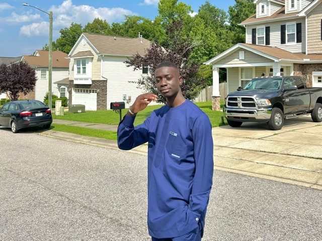Abdoulie Salla poses in a traditional Senegalese outfit for an annual Islamic celebration, Eid. Salla likes to spend time with his family and tries his best to maintain a balance between his school and home life. (Photo courtesy of Abdoulie Salla)