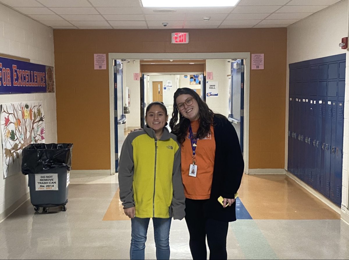 Breana and Thomas in the hallway enjoying a walk in the hallway together. This shows the great relationship between Thomas as a teacher and her dear student. 