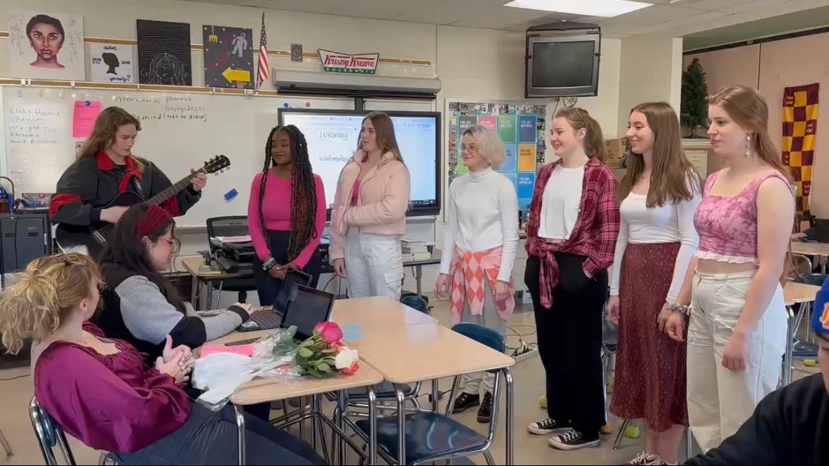 One group of choir students (pictured) sing Our Song for a student during English Class. This group and many other groups of  choir students spend Valentines Day singing for students.