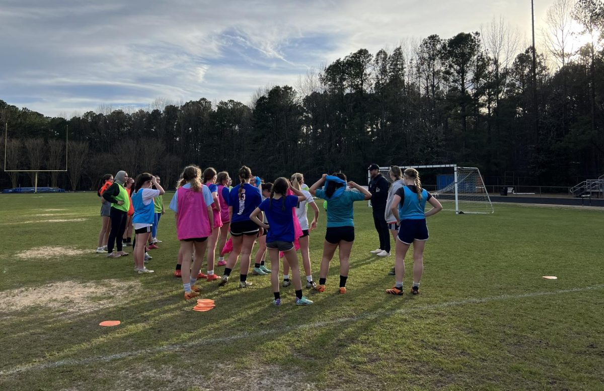Coach Eric Long talking to girls trying out for soccer after the final workout before tryouts. Photos Courtesy of Mackenzie Dixon