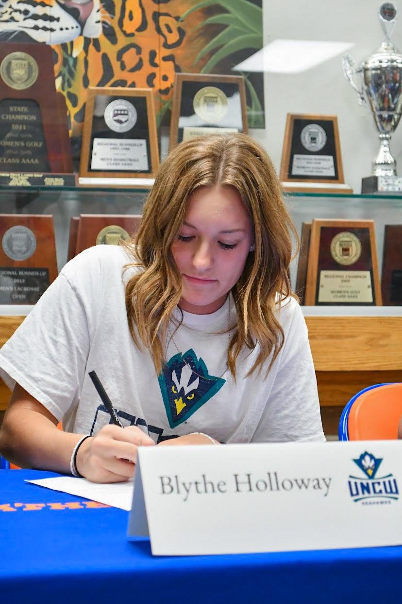 Blythe Holloway signs a commitment to swim for UNCW. (Photo courtesy of Blythe Holloway).