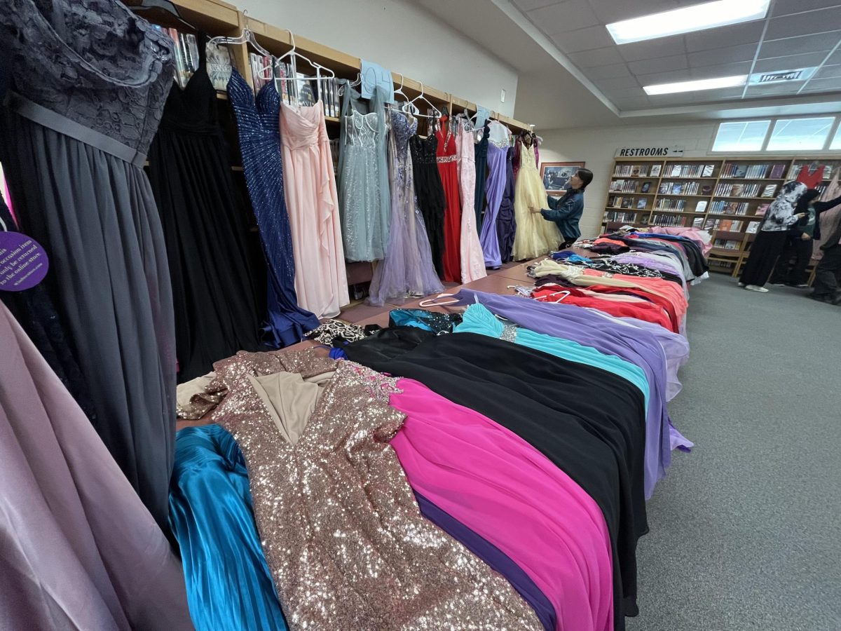 Teagan Grantz (Senior) arranging the donated dresses for students to choose from