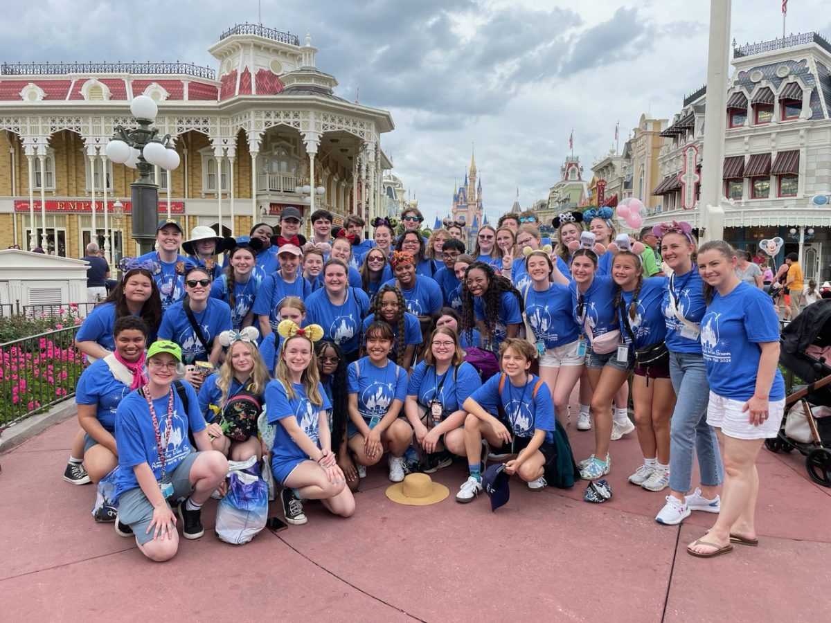 Performing arts students gather in Main Street to take a group photo on their last day. Directors Ashlynn Hayes and Erin Santa-Croce join the group for their final moments in Magic Kingdom before heading back to Raleigh. Students traveled to Disney World as part of a Disney initiative (known as Sing the World Tour powered by World Strides) to have high school groups sing and convey a sense of world connectivity. 