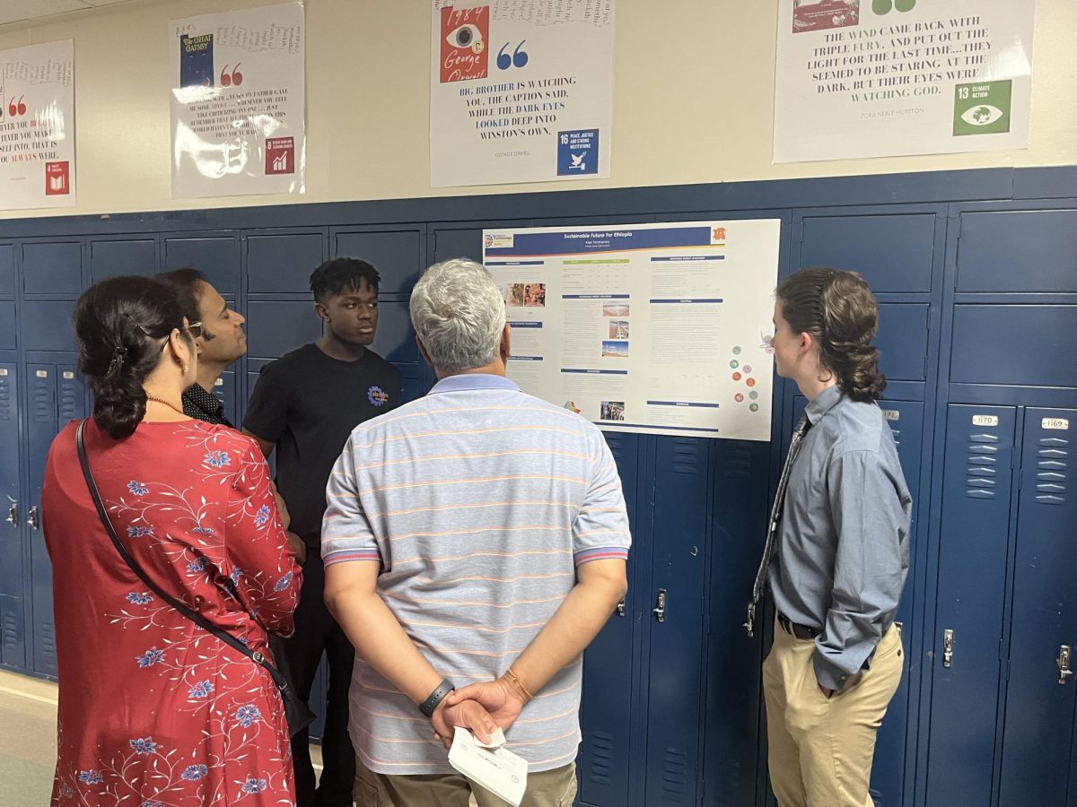 Freshman students present their STEM projects to parents, focused on creating energy portfolios for foreign countries. Many parents and faculty members viewed student presentations.