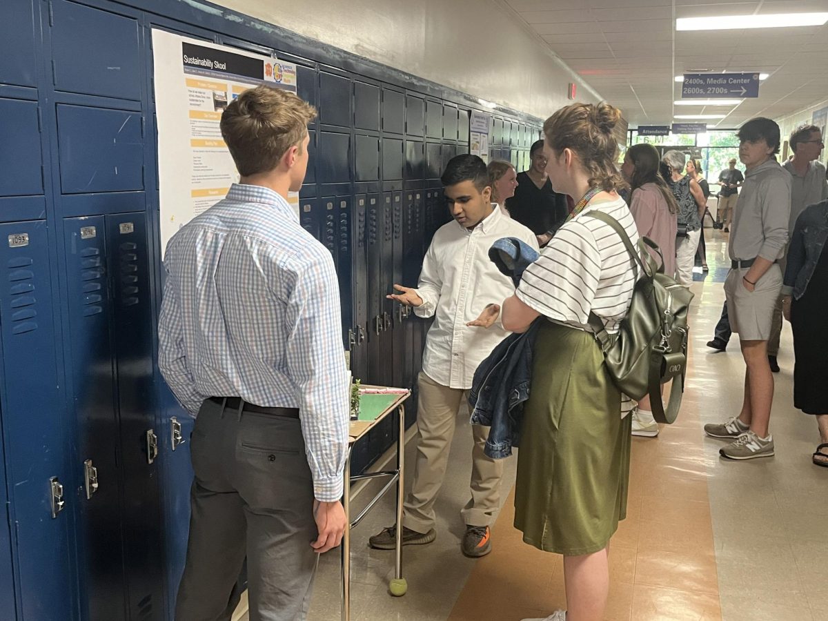 Two students present their STEM Project to Michaela Connors, STEM teacher. Connors provided feedback on many ideas shared about making Athens Drive more sustainable for potential implementation.