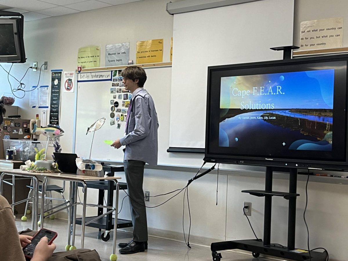 Daniel Hofman presents his Senior STEM project to a classroom of attendees. Seniors spent a semester in STEM Capstone class, planning out a project to provide local solutions to an environmental issue.