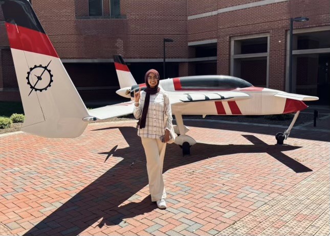 Senior+Maryum+Irfan+poses+with+a+plane.+She+hopes+to+one+day+make+planes+once+she+enrolls+into+NC+State+for+a+major+in+Aerospace+Engineering.