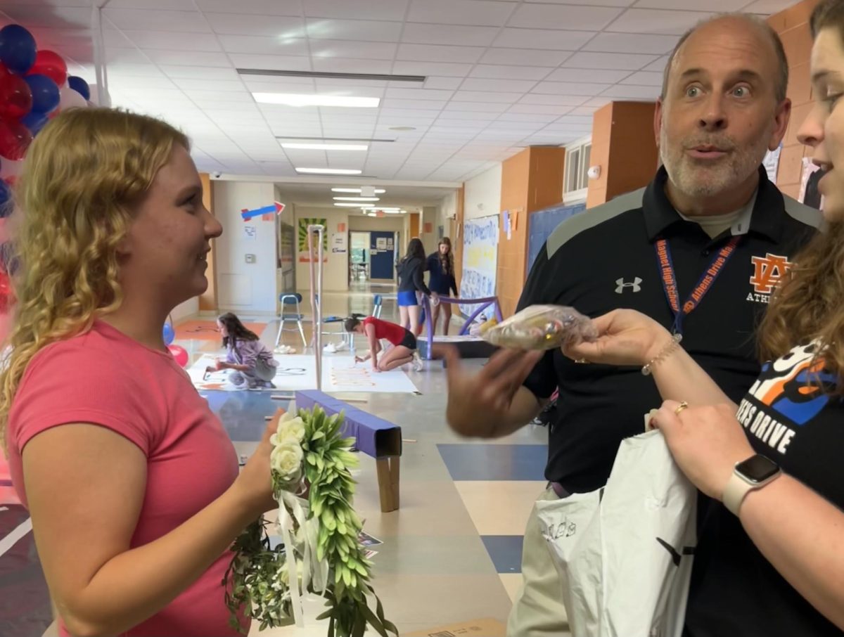 McGraw talking to Mr. Remaley and Mrs. Lassiter about Homecoming decorations. Student council works collaboratively with these teachers to have the best possible event outcomes. (Photo Courtesy of Ava Sheppard)