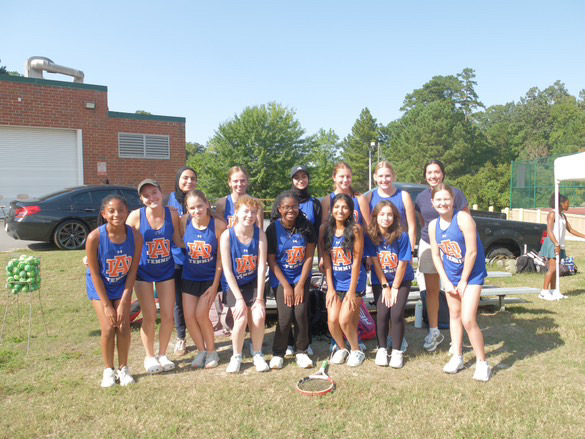 The picture above shows the tennis team posing for a group picture. They took a group picture together with the coach oct. 7th at Enloe High School after their competition. 