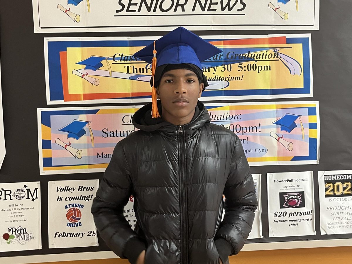 Jeremiah Judd is a senior in the mid year graduating class of 2025. The board behind him talks about all things senior related and graduation dates. Photo Courtesy: Kierra Moore