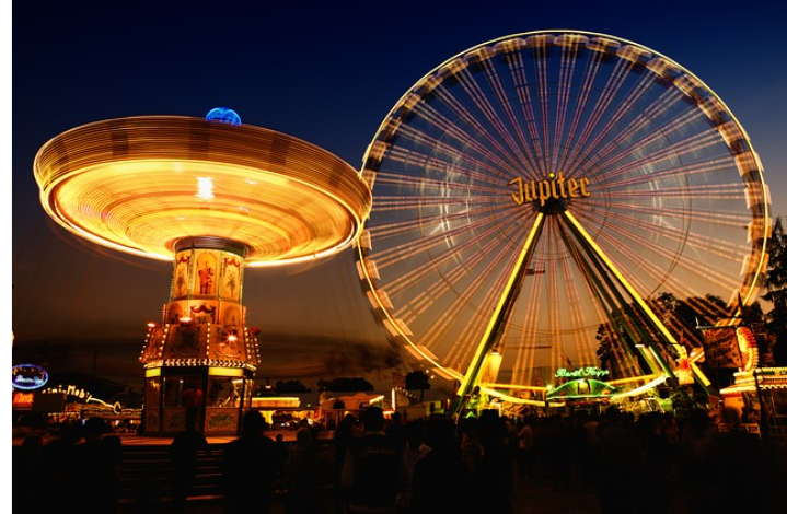 The iconic ferris wheel Jupiter, lights up the night alongside the Merry-Go-Round.