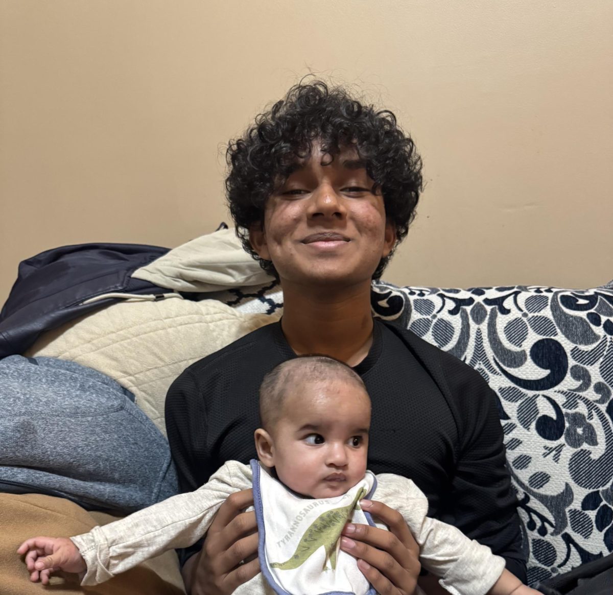 Ayan is photographed by his Uncle while he holds his nephew