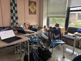 Students mimicking a code-red drill squat in the corner of a classroom in an effort to protect themselves in a scary situation.