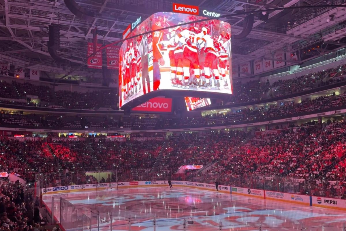 The Lenovo Stadium Jumbotron lights up with the Carolina Hurricanes’ pregame show following warmups for Eastern Conference Finals Game 5 against the Florida Panthers, hyping up the crowd with highlights of key moments and star players from the season. It’s a powerful tribute to the vital plays that brought the Canes to where they are, setting the tone for the exciting game that follows. (Photos by Riley Erklin)

