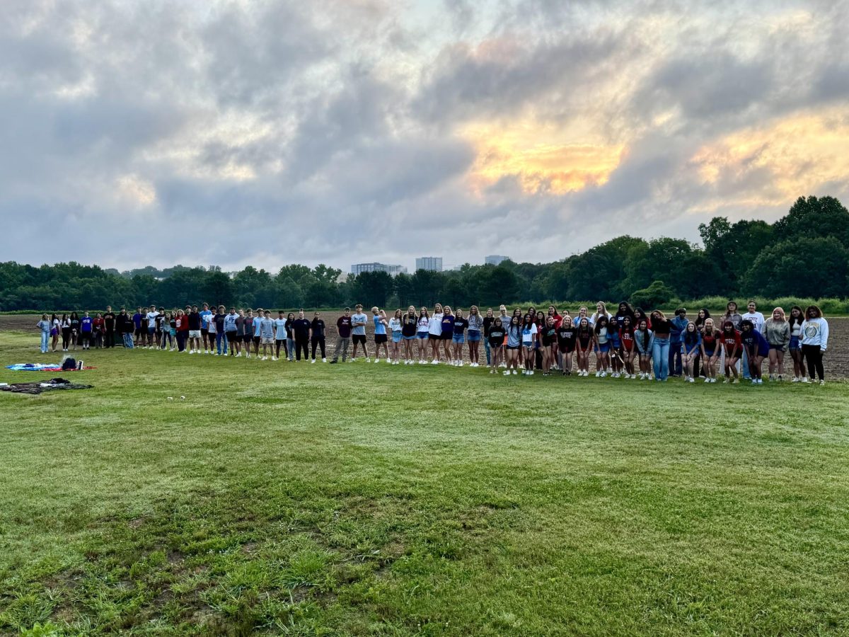 Athens Drive seniors pictured at Dorothea Dix Park. The seniors dressed in college shirts on their last day of school, waking up early to watch the sunrise.