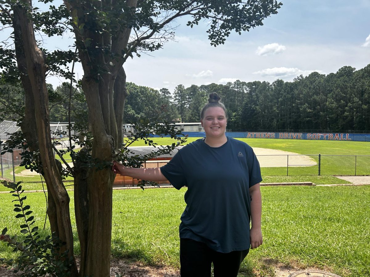 Heidi Bertz is posing by the tree for her solo picture. She was nominated for the senior spotlight. 
