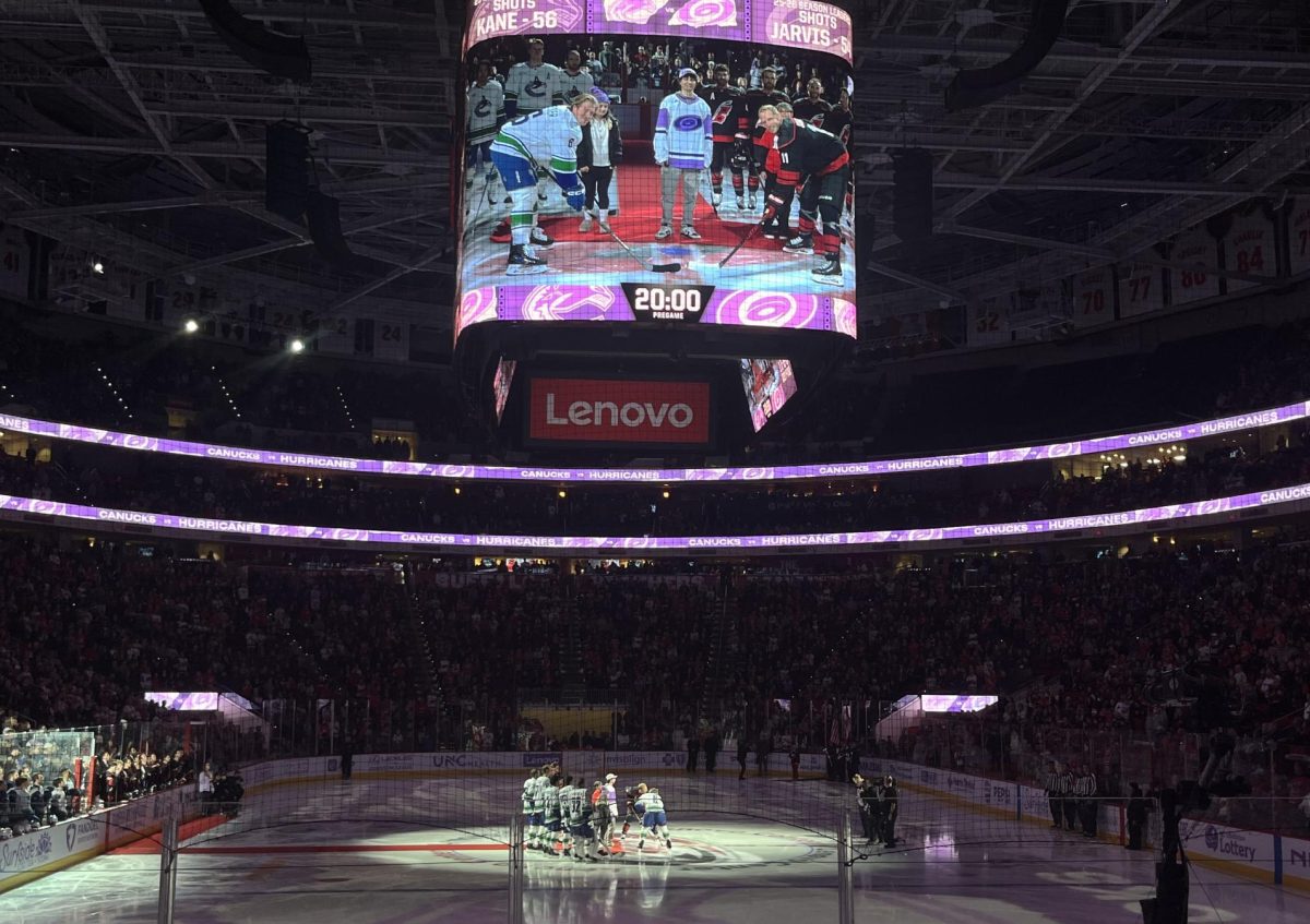 Vancouver Canucks’ center Brock Boeser and Carolina Hurricanes’ Jordan Staal faceoff on the Hurricane’s Hockey Fights Cancer game. The night is dedicated to raising money for funding pediatric cancer research at UNC.
