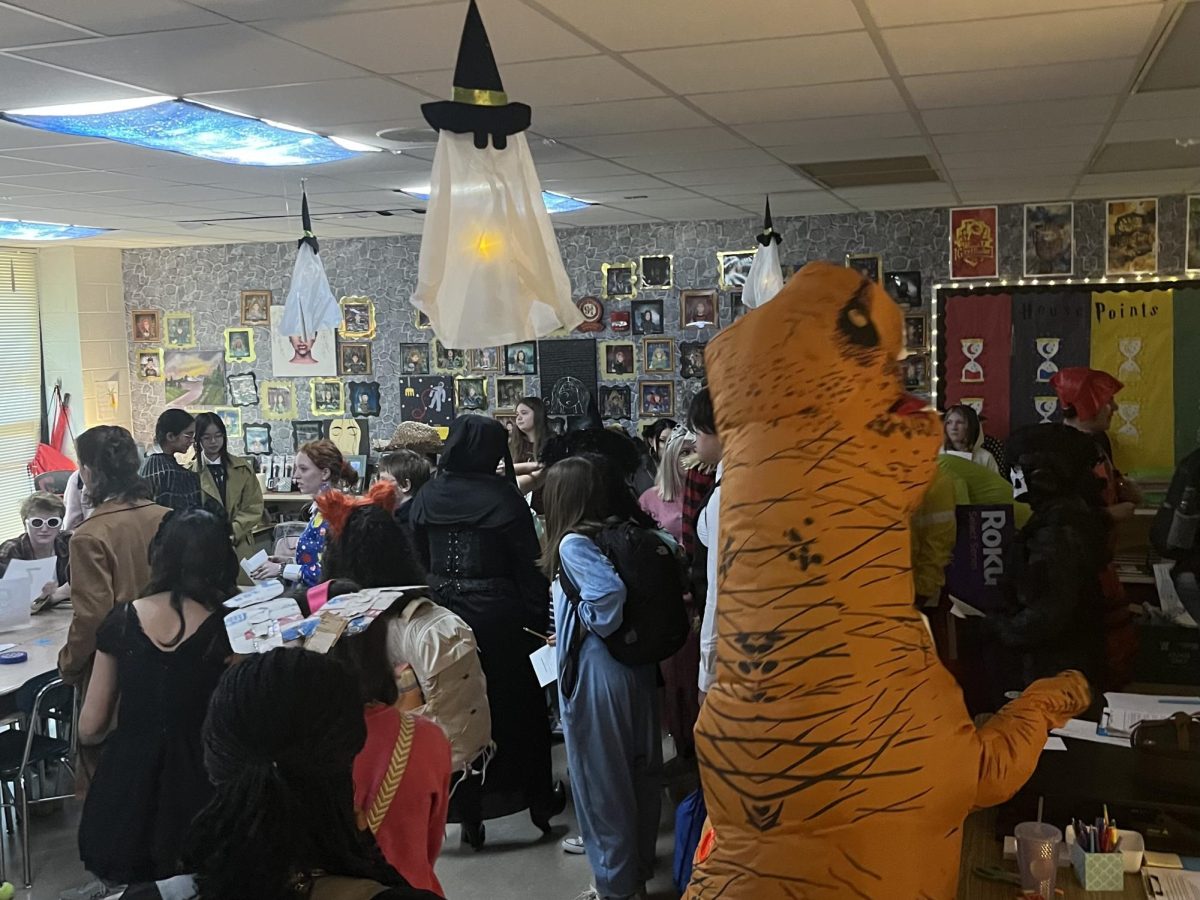 A group of students in the classroom dressed in their costumes. Many students took their costumes to the next level by showing off their creativity.