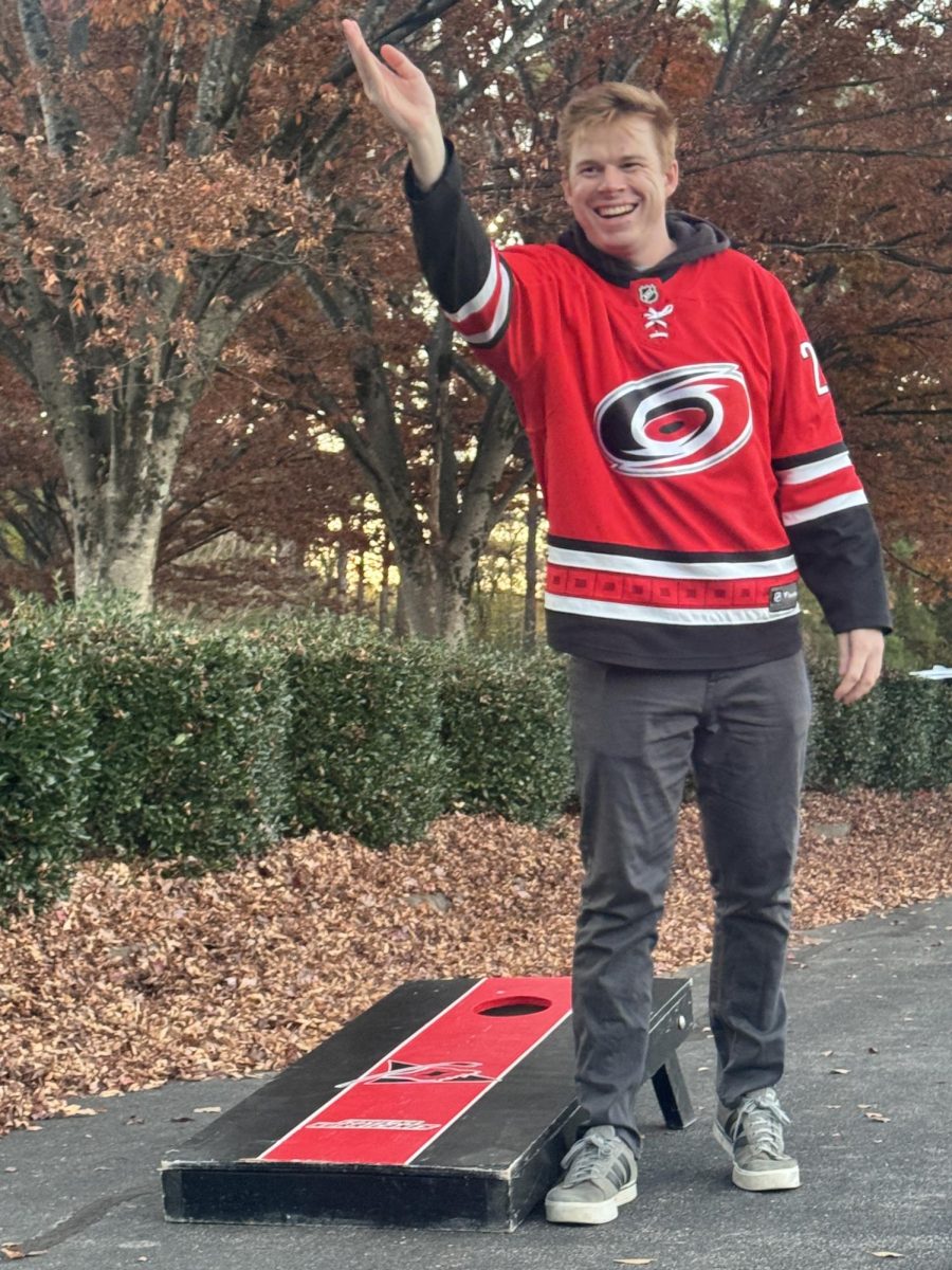 Hurricanes fan is pictured smiling during a game of cornhole outside of Lenovo center. He was photographed before the game on Nov. 14, tailgating before the game against the Vancouver Canucks.