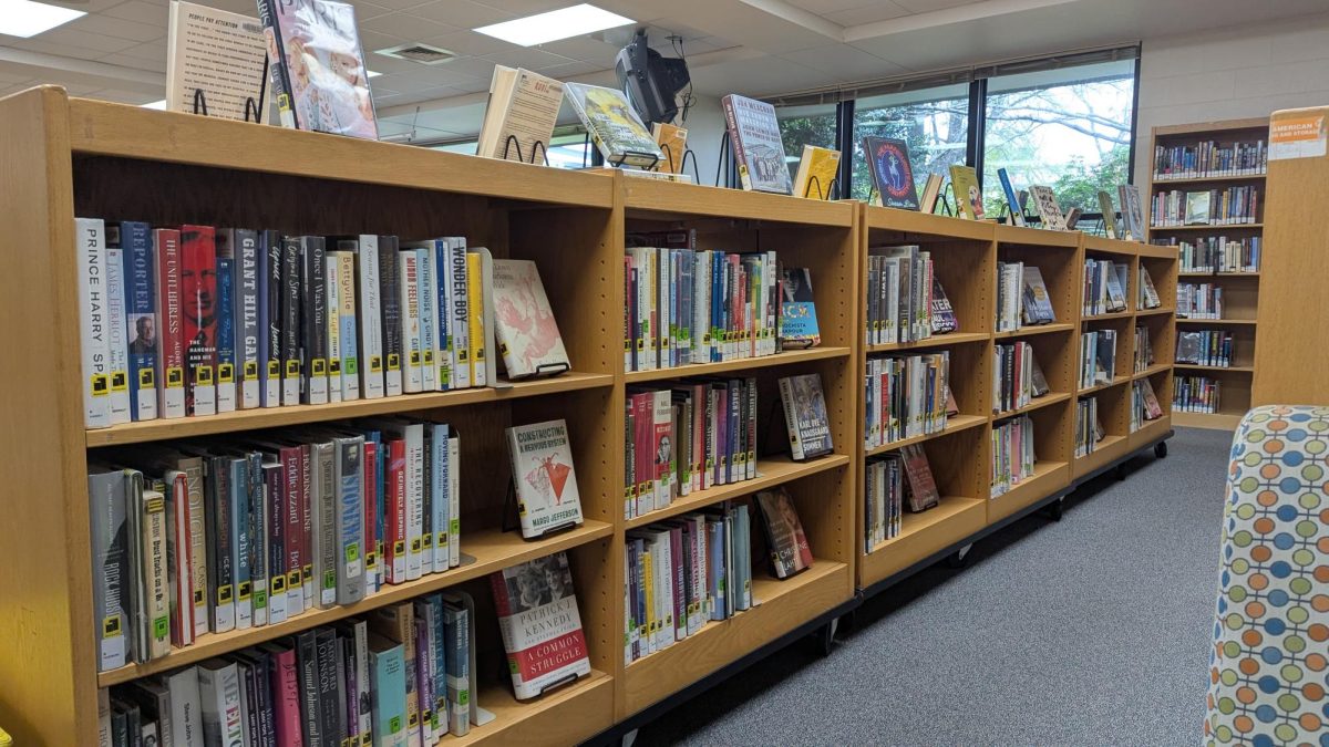 Bookshelves in the Athens Drive Community Library. Various books are placed on them for library patrons to read and check out.