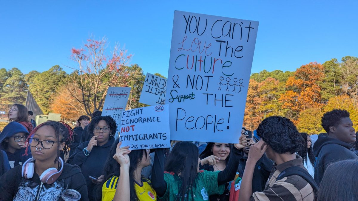 A group of students attending the Athens Ice-Out protest. Several of them held signs urging people to support immigrants.