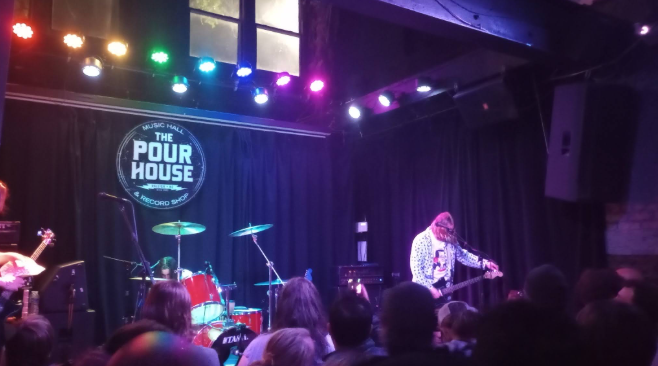 A tribute band for Nirvana called Nirvani performing at the Pour House. The band try to encapsulate the original music showing love for the original band.