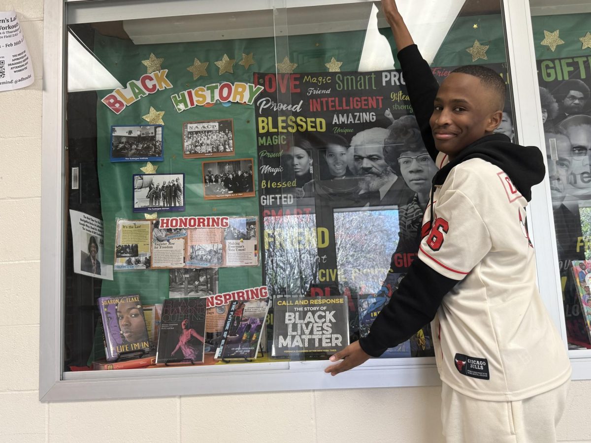 Elijah Hoskins featured standing in front of Athens Drive Black History Month gallery.