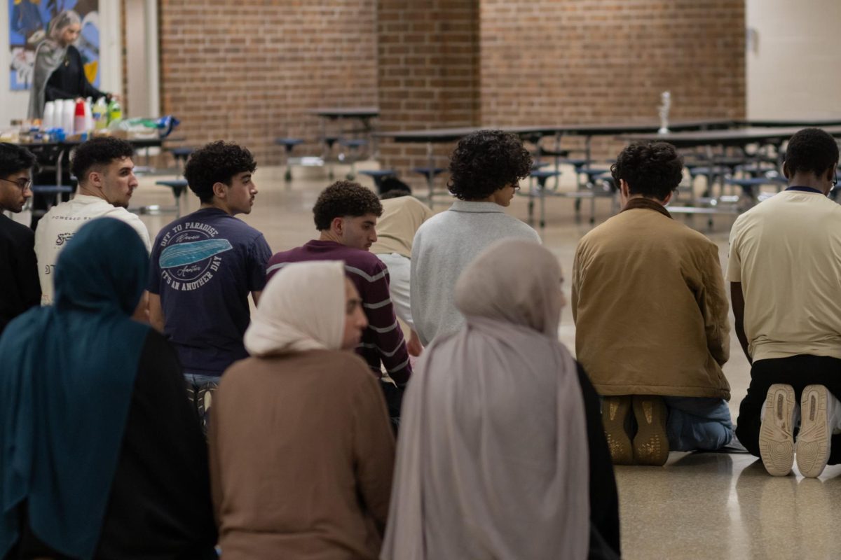 Omar Abazid (red) as seen along with the group, wrap up their prayer. Everyone finished their prayer after a long day of fasting
