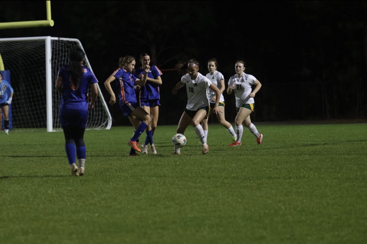 A player controls the ball in the middle of the field while her teammates move around her and defender get ready to stop her, this moment shows the team working together and trying their best just like their coach said.
(Courtesy of Athens Drive Women's Soccer)