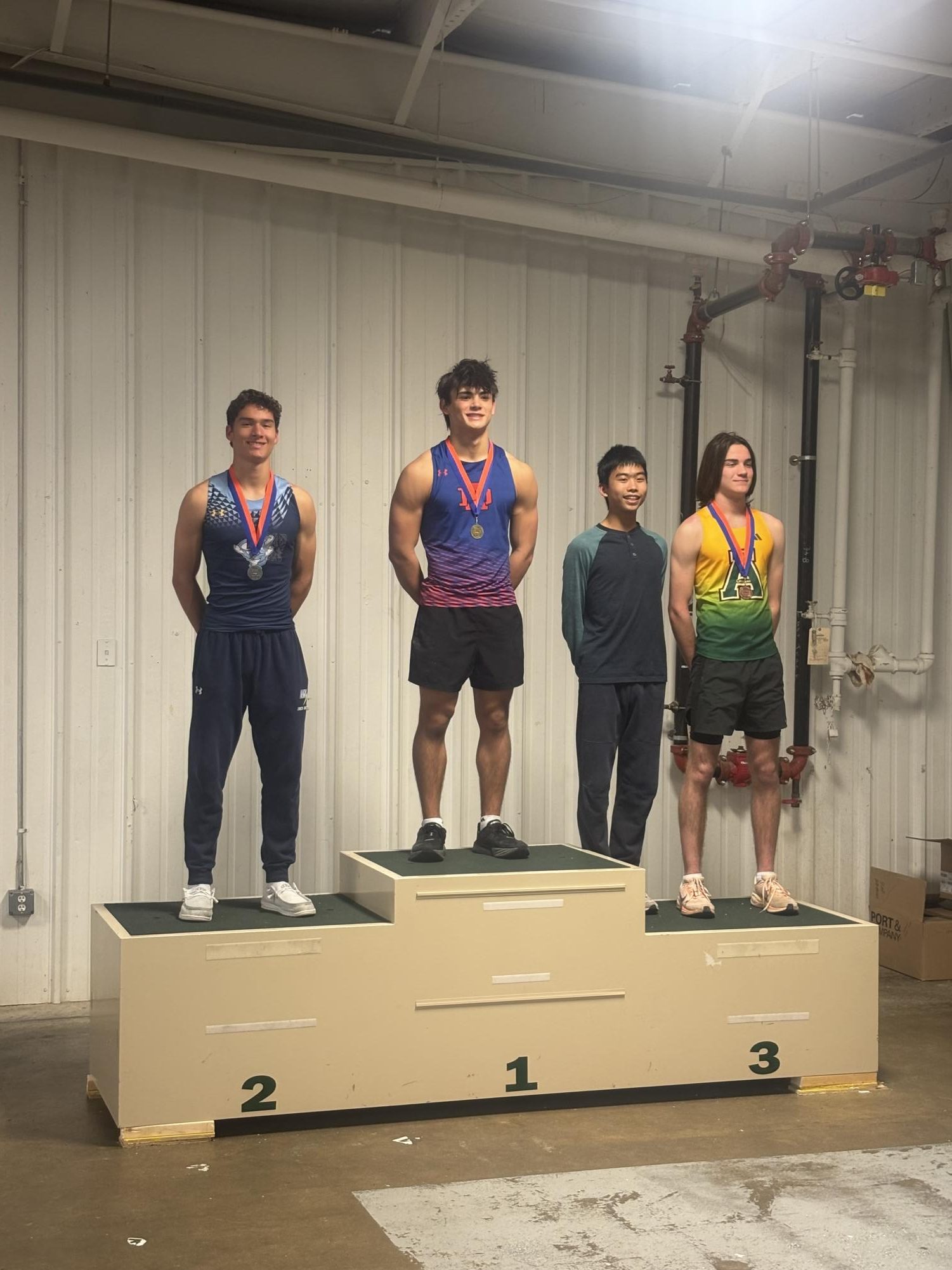 James Witt stands on the first place block on the podium. This is from the Indoor season, after his 15-06 meter jump placed him ahead of the other competitors. (Photos Courtesy of Travis Seese)